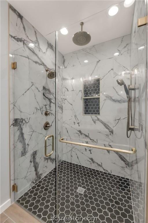 bathroom with a shower with shower door