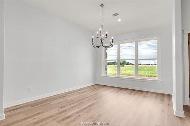 unfurnished dining area with light hardwood / wood-style flooring and a chandelier