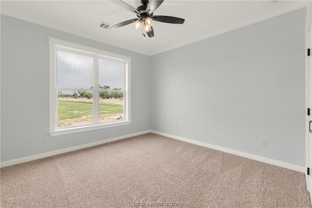 carpeted spare room with ceiling fan