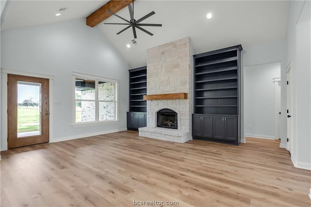 unfurnished living room featuring beamed ceiling, light hardwood / wood-style floors, a fireplace, and high vaulted ceiling