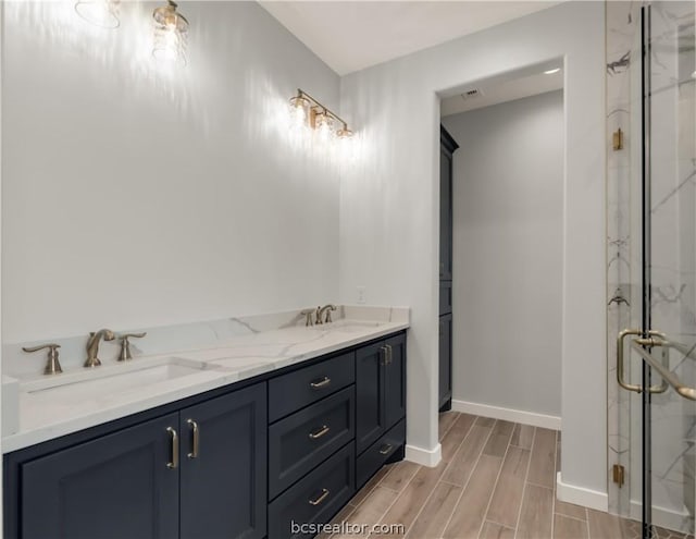 bathroom featuring vanity, hardwood / wood-style flooring, and an enclosed shower