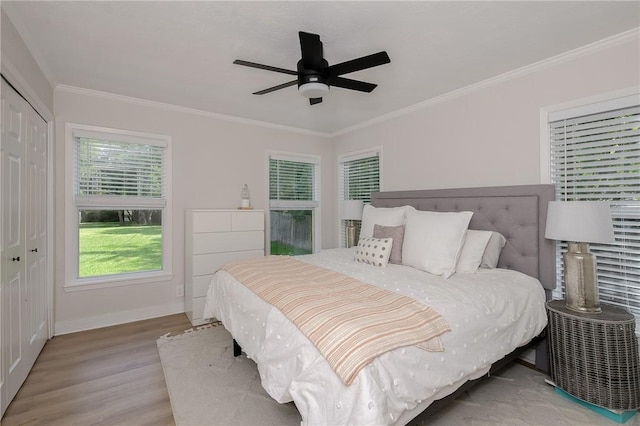 750 Garden Acres Blvd, Bryan, TX 77802 - bedroom featuring wood finished floors, a closet, ornamental molding, and ceiling fan