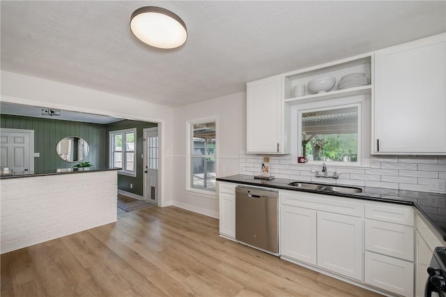 750 Garden Acres Blvd, Bryan, TX 77802 - kitchen featuring stainless steel dishwasher, open shelves, dark countertops, decorative backsplash, and a textured ceiling