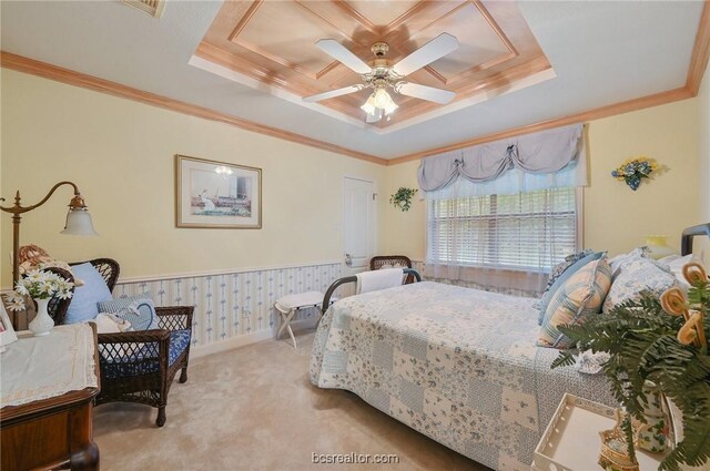 carpeted bedroom featuring a tray ceiling, ceiling fan, and crown molding