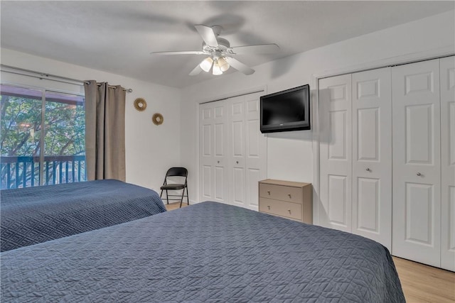 bedroom with light wood-style floors, two closets, ceiling fan, and access to outside
