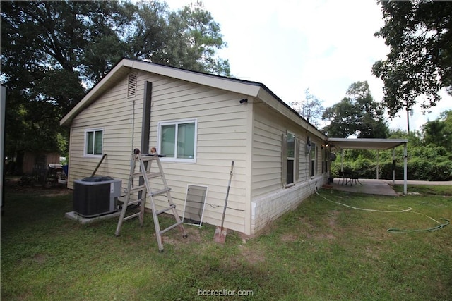 view of home's exterior with central AC unit, a patio area, and a lawn