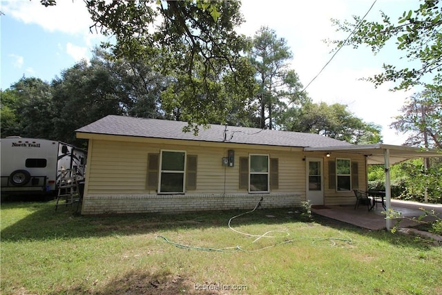 back of house with a yard and a patio area