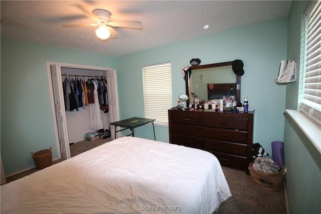 carpeted bedroom featuring ceiling fan, a closet, and a textured ceiling