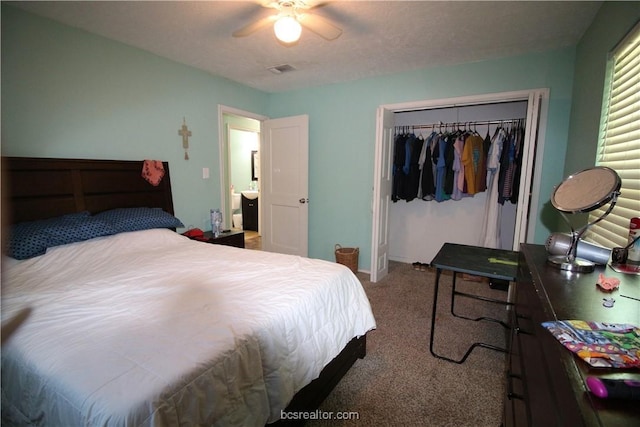 carpeted bedroom with ceiling fan and a closet