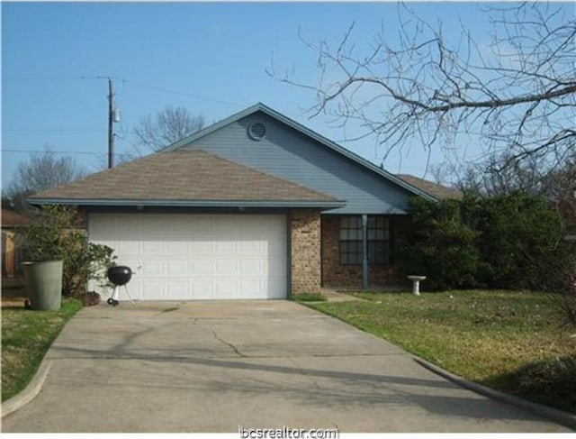 single story home featuring a garage and a front lawn