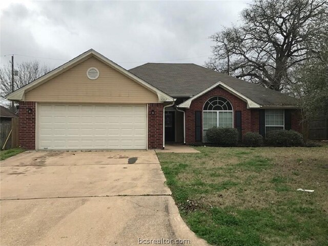 single story home featuring a garage and a front lawn