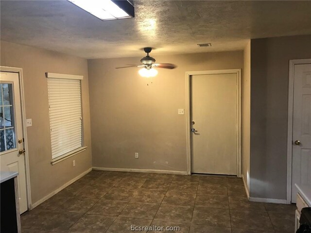 tiled foyer entrance featuring ceiling fan