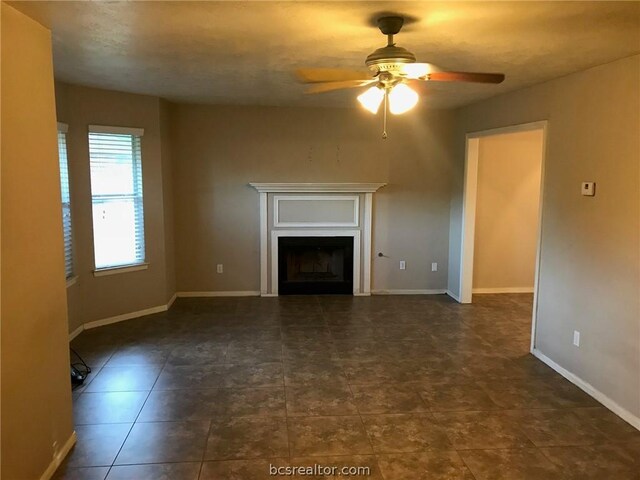 unfurnished living room featuring ceiling fan