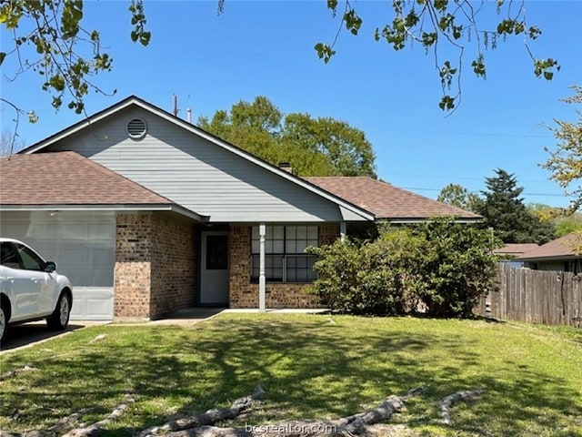 ranch-style home with a front yard and a garage