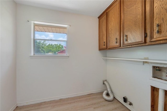 1905 Nueces Dr, College Station, TX 77840 - laundry room with cabinet space, light wood-style floors, and hookup for a washing machine