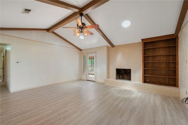 1905 Nueces Dr, College Station, TX 77840 - unfurnished living room with wood finished floors, a ceiling fan, a fireplace, and built in features