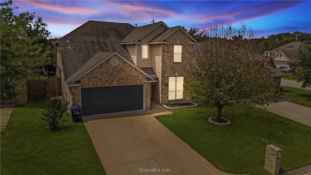 view of front of house with a garage and a lawn