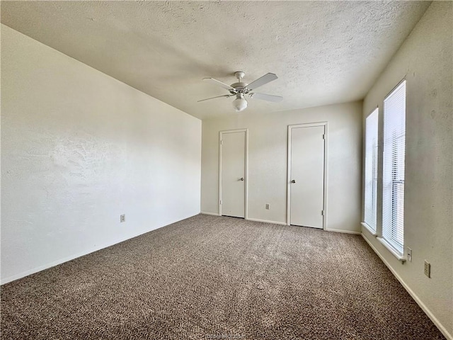 unfurnished bedroom with carpet flooring, ceiling fan, and a textured ceiling