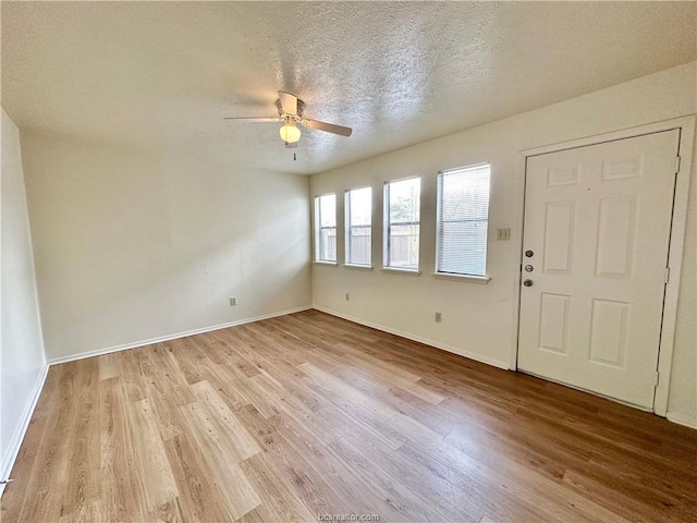 entrance foyer with a textured ceiling, light hardwood / wood-style flooring, and ceiling fan