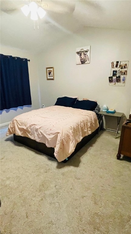 bedroom featuring carpet, vaulted ceiling, and ceiling fan