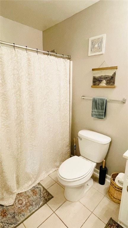 bathroom featuring toilet, tile patterned flooring, visible vents, and vaulted ceiling