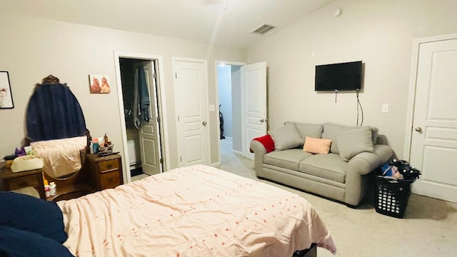 bedroom featuring lofted ceiling, visible vents, and light carpet