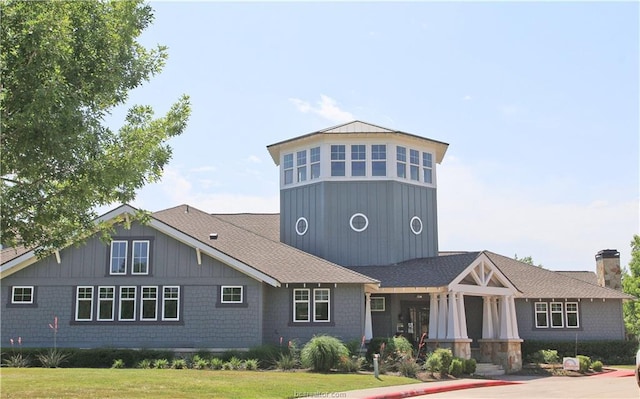 view of front of house featuring a chimney and a front yard