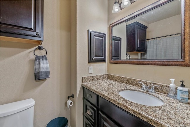 bathroom with toilet and vanity