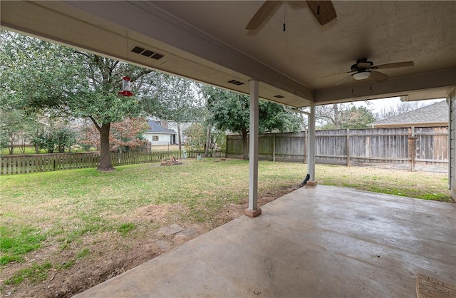 view of yard with a fenced backyard, a patio, and ceiling fan