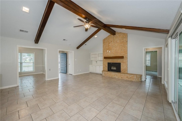 unfurnished living room with light tile patterned floors, baseboards, visible vents, lofted ceiling with beams, and a brick fireplace