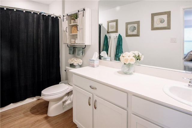 full bathroom featuring curtained shower, wood finished floors, toilet, and vanity