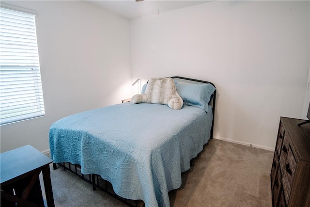 bedroom with carpet and baseboards