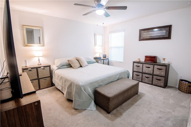 bedroom featuring light carpet and ceiling fan
