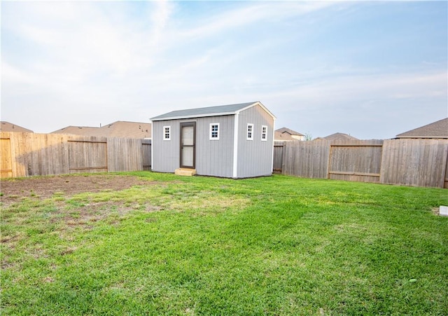 view of yard featuring an outdoor structure and a fenced backyard