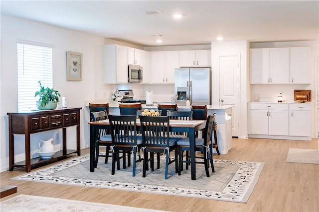 dining space with recessed lighting, visible vents, and light wood-style flooring