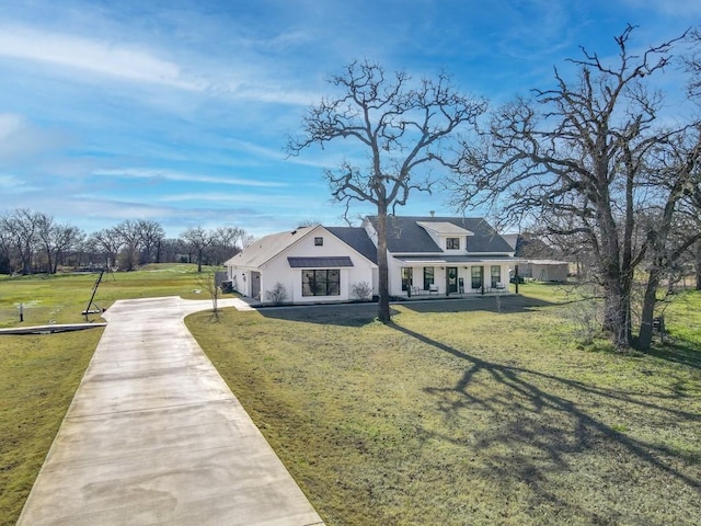 view of front of home with a front yard and covered porch