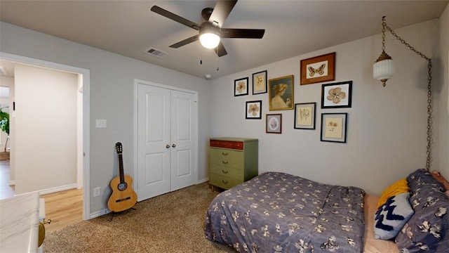 carpeted bedroom with a closet and ceiling fan