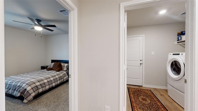 bedroom featuring washer / dryer, ceiling fan, and light hardwood / wood-style floors