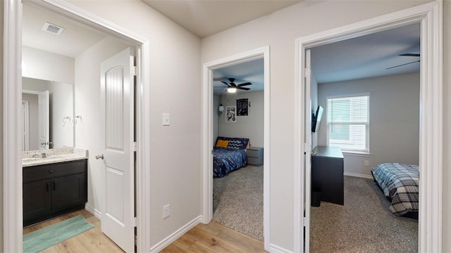 bathroom with vanity, wood-type flooring, and ceiling fan