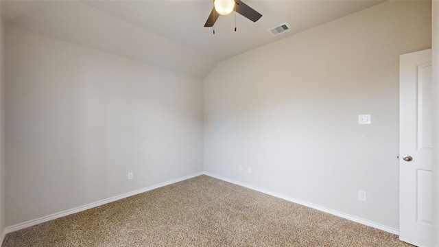 carpeted empty room with vaulted ceiling and ceiling fan