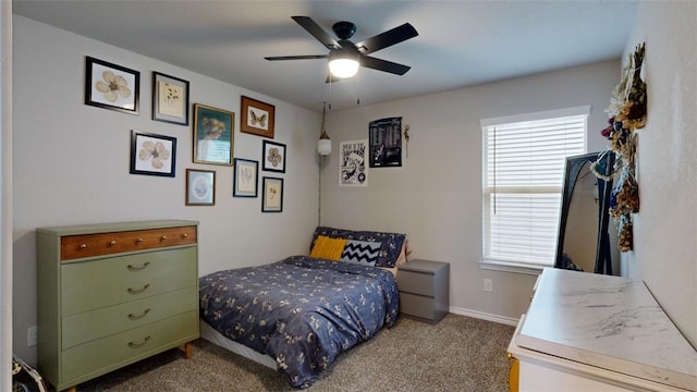 bedroom featuring multiple windows, light colored carpet, and ceiling fan