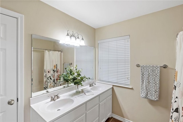 full bath with a sink, double vanity, and curtained shower