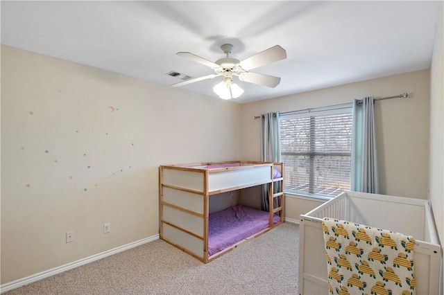 unfurnished bedroom featuring baseboards, visible vents, and light carpet