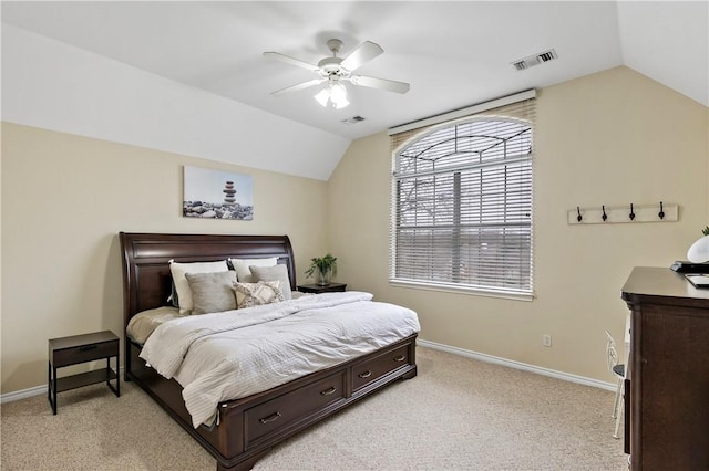 bedroom with light colored carpet, visible vents, vaulted ceiling, and baseboards