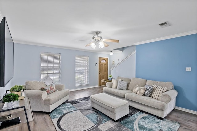 living room with visible vents, dark wood finished floors, and crown molding