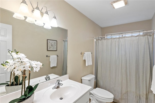 bathroom with vanity, toilet, and visible vents