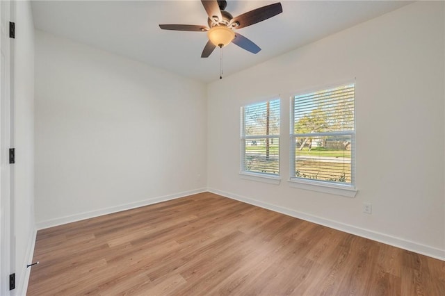 spare room with ceiling fan, a healthy amount of sunlight, and light hardwood / wood-style floors