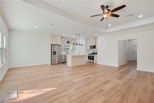 unfurnished living room with light hardwood / wood-style flooring, ceiling fan, and sink