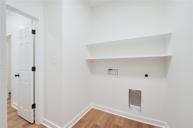 clothes washing area featuring electric dryer hookup, hookup for a washing machine, and light hardwood / wood-style flooring