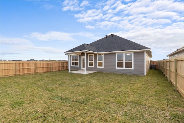 rear view of property featuring a lawn